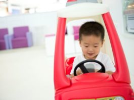 Playing with ride-in car toy