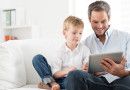 father and son playing on a tablet