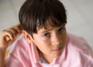 Boy combing hair